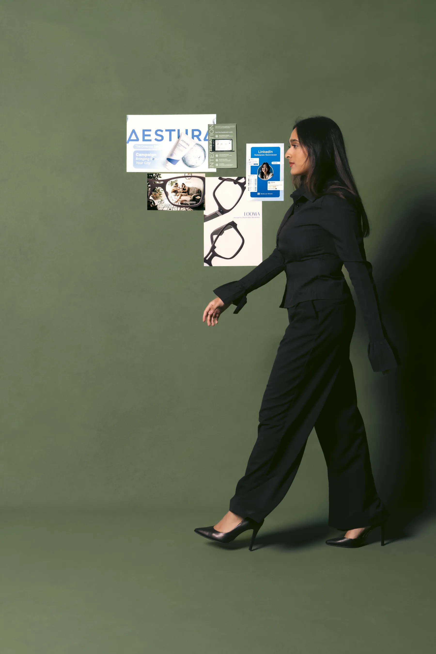 Kavya walking past a wall of her design work