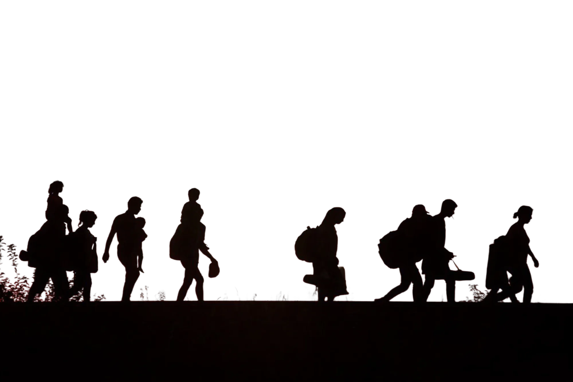 Silhouettes of people walking at dusk, carrying their belongings